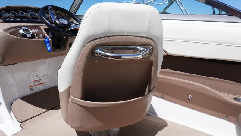 Slide: The Image of 2014 Cobalt 210 boat interior with beige seating and steering wheel. - 38