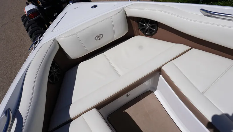 Slide: The Image of 2014 Cobalt 210 boat interior with white leather seating and speaker system. - 42