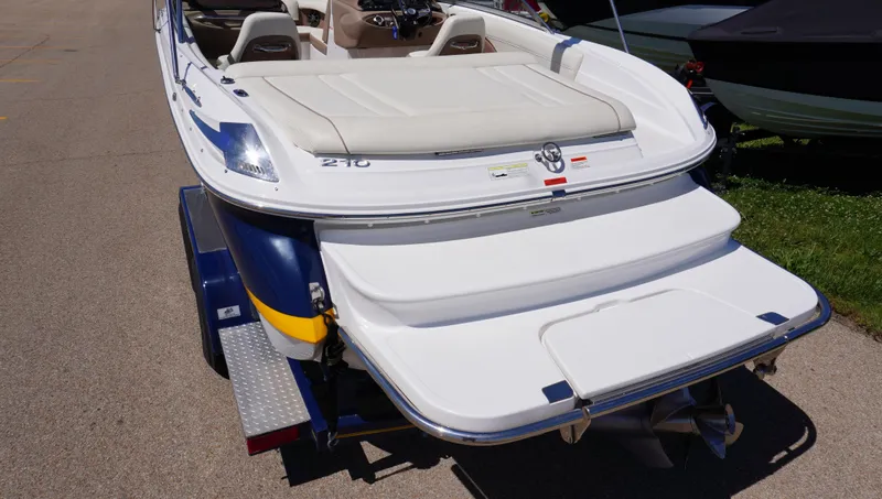Slide: The Image of 2014 Cobalt 210 boat on trailer, rear view showing swim platform and seating. - 8