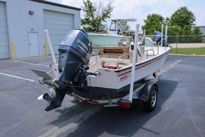 Slide: The Image of 1995 Boston Whaler 17 Montauk boat with Yamaha engine on trailer in parking lot. - 1