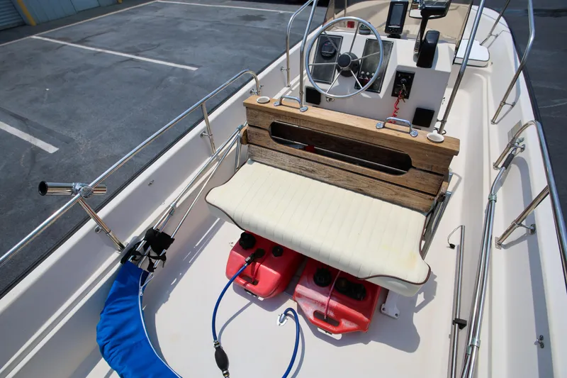 Slide: The Image of 1995 Boston Whaler 17 Montauk boat interior with steering wheel and seating. - 10