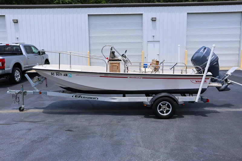 Slide: The Image of 1995 Boston Whaler 17 Montauk boat on trailer, parked outside storage facility. - 4