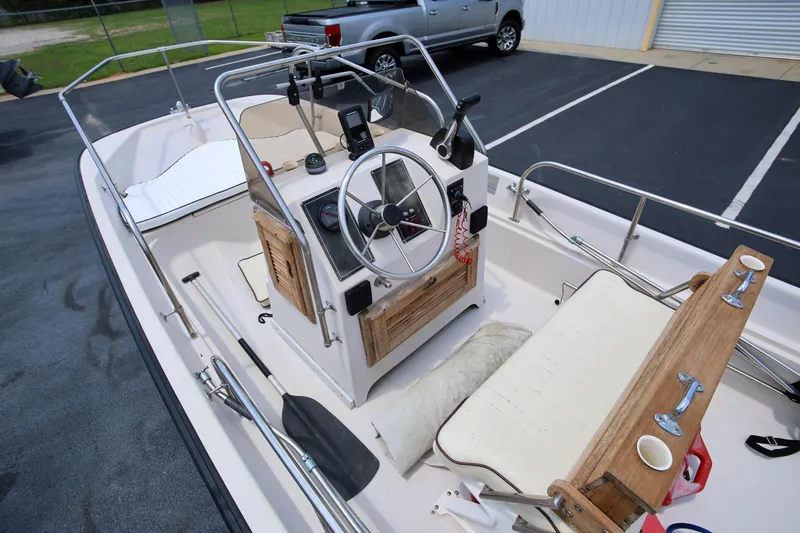 Slide: The Image of 1995 Boston Whaler 17 Montauk boat interior with steering wheel and seating. - 6