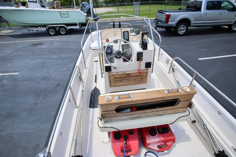 Slide: The Image of 1995 Boston Whaler 17 Montauk boat interior with steering wheel and controls. - 7