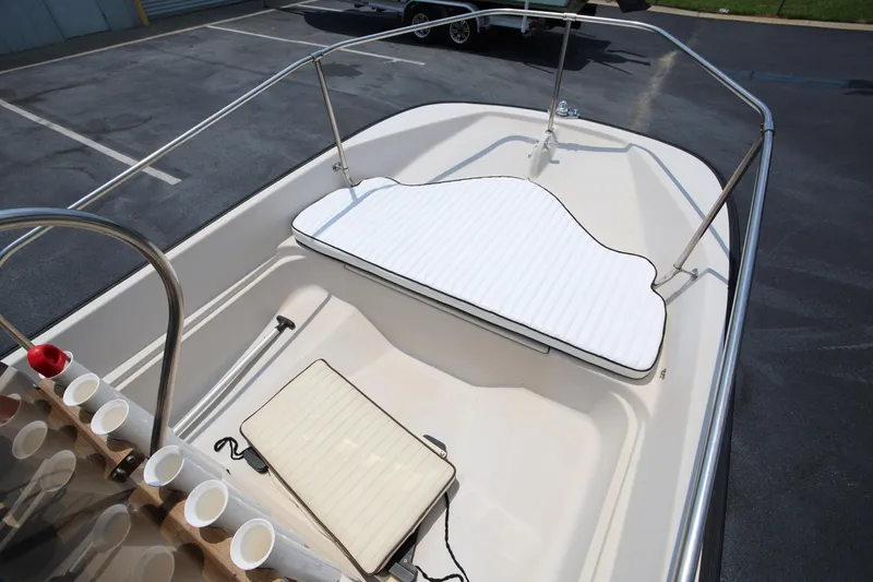 Slide: The Image of 1995 Boston Whaler 17 Montauk boat interior with white seating and cup holders. - 9