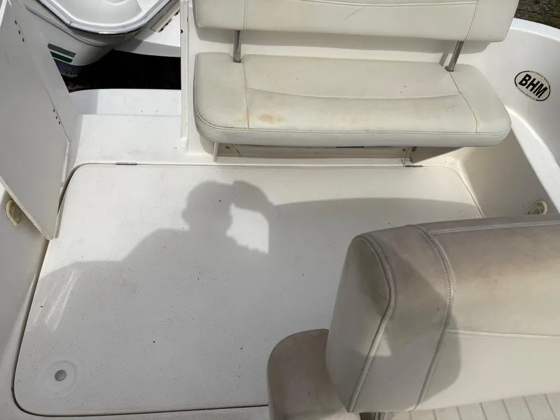 Slide: The Image of 2007 Bayliner 245 Cruiser interior with white seating and open deck area. - 13