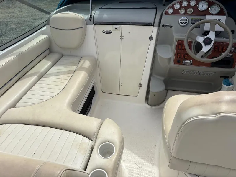 Slide: The Image of 2007 Bayliner 245 Cruiser interior with seating, steering wheel, and control panel. - 15