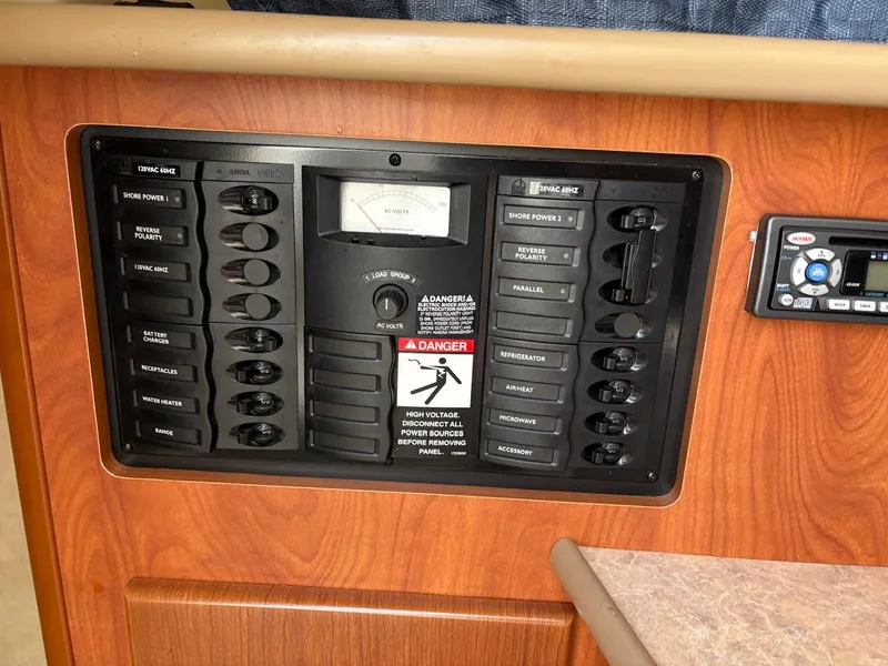 Slide: The Image of Control panel of a 2007 Bayliner 245 Cruiser with switches and warning label. - 5