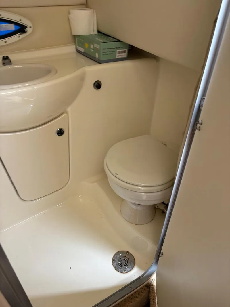 Slide: The Image of 2007 Bayliner 245 Cruiser bathroom with sink, toilet, and storage. - 6