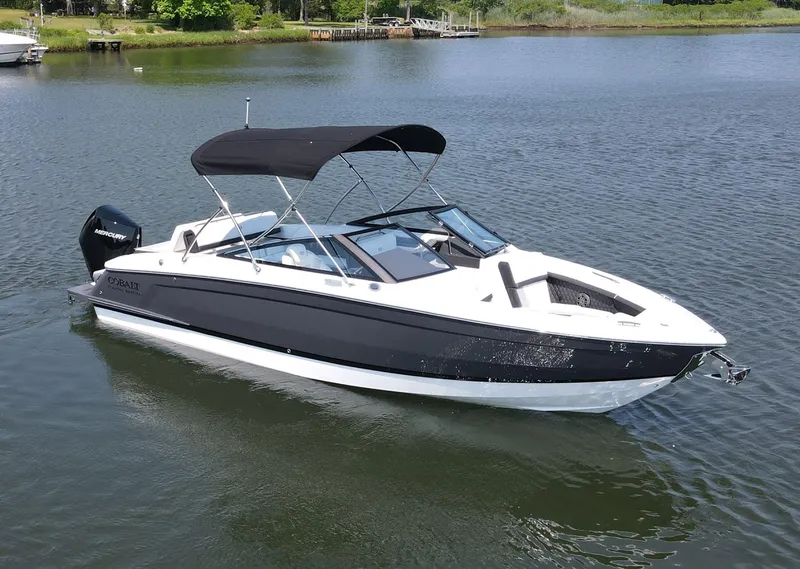 The Image of 2024 Cobalt R4 Outboard boat with black canopy on calm water. - 0