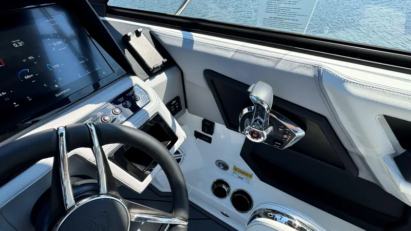 Slide: The Image of 2024 Cobalt R4 Outboard boat dashboard with steering wheel and control panel. - 13
