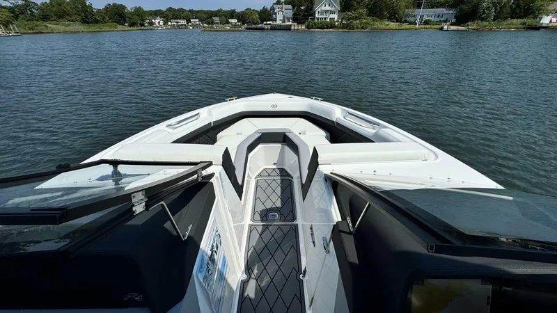 Slide: The Image of 2024 Cobalt R4 Outboard boat on calm water, featuring sleek design and spacious seating. - 15