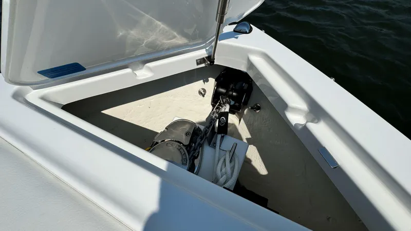 Slide: The Image of 2024 Cobalt R4 Outboard storage compartment with open lid, showcasing interior details. - 18