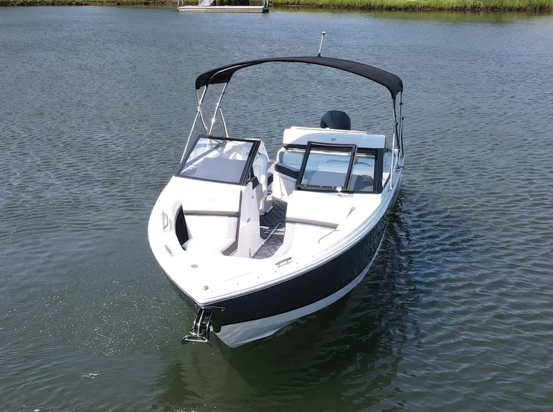 Slide: The Image of 2024 Cobalt R4 Outboard boat on calm water, featuring sleek design and black canopy. - 4