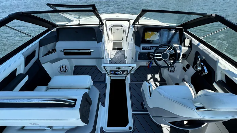 Slide: The Image of 2024 Cobalt R4 Outboard boat interior with modern dashboard and seating on water. - 6