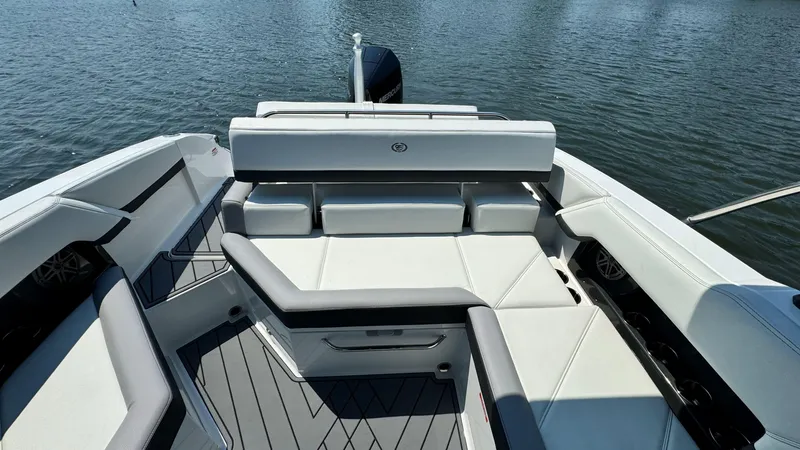 Slide: The Image of 2024 Cobalt R4 Outboard boat with luxurious seating on calm water. - 7