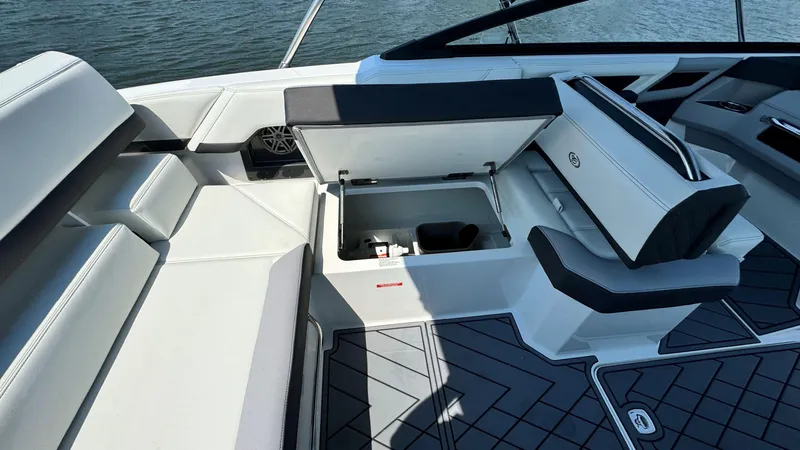 Slide: The Image of 2024 Cobalt R4 Outboard boat interior with open storage compartment and seating. - 8