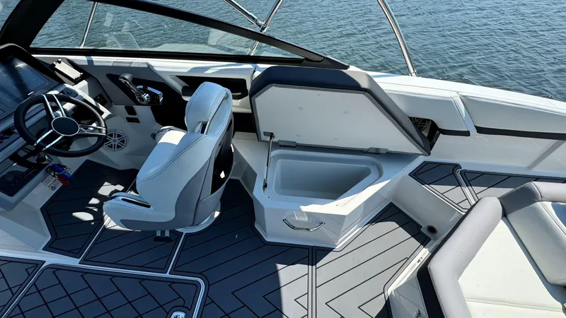 Slide: The Image of 2024 Cobalt R4 Outboard boat interior with seating and storage, on calm water. - 9