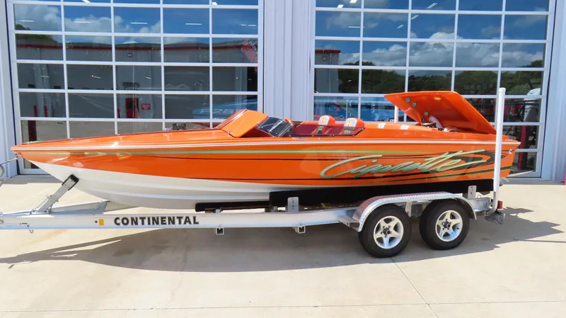 The Image of 1979 Cigarette 20 speedboat in vibrant orange on a Continental trailer. - 0
