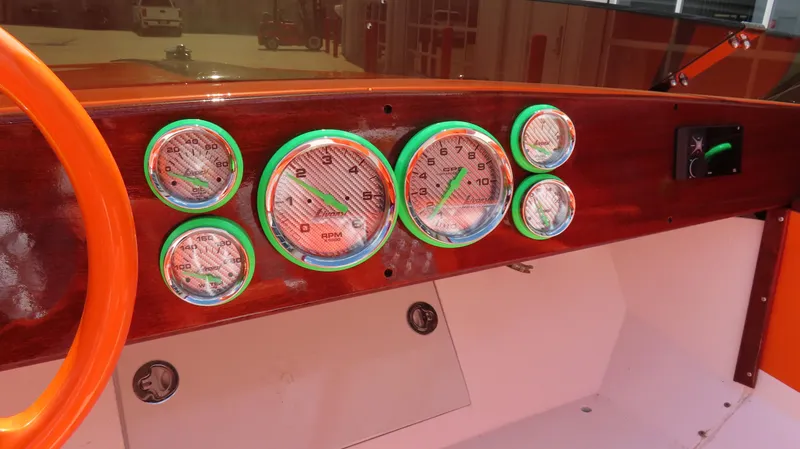 Slide: The Image of Dashboard of a 1979 Cigarette 20 boat with colorful gauges and orange steering wheel. - 12