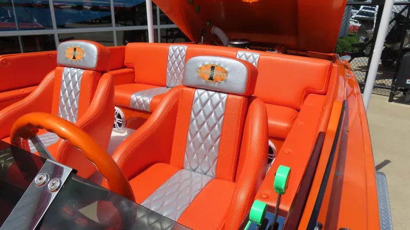 Slide: The Image of 1979 Cigarette 20 boat interior with vibrant orange and silver seats, showcasing luxury design. - 16