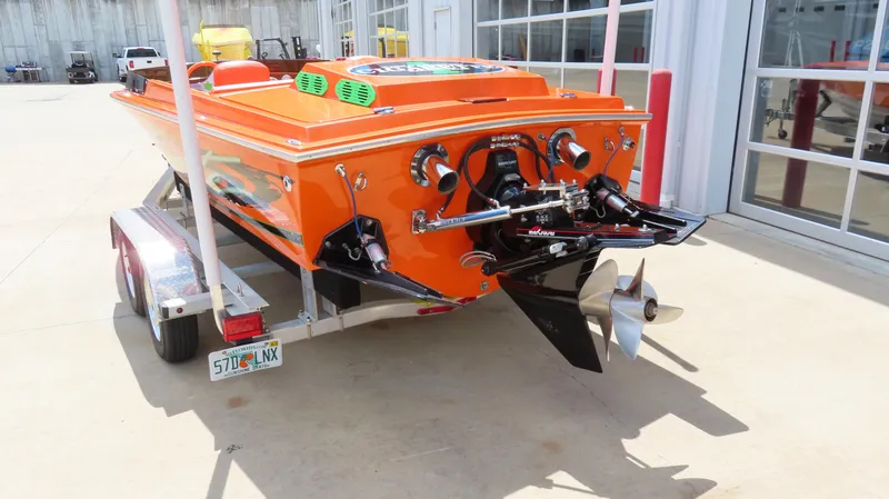 Slide: The Image of 1979 Cigarette 20 boat in orange on trailer, rear view showing propeller and engine. - 17