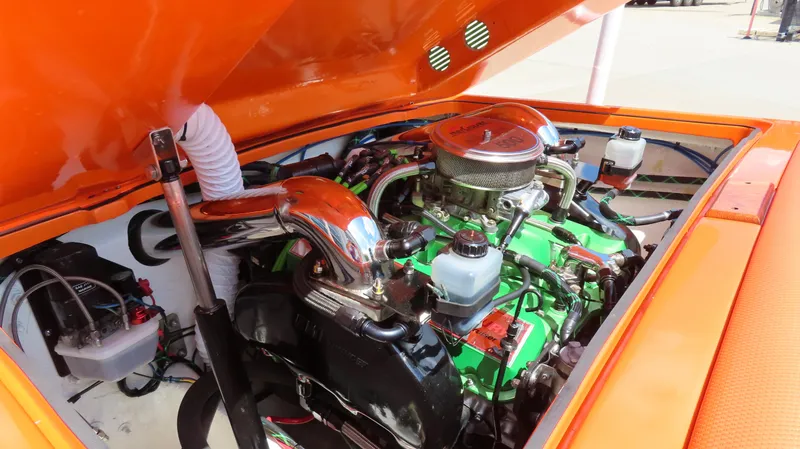 Slide: The Image of 1979 Cigarette 20 boat engine with vibrant green and chrome components under an orange hood. - 7