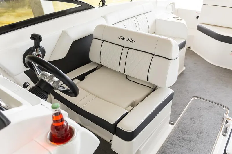 Slide: The Image of 2016 Sea Ray 270 Sundeck boat with black cover in storage facility. - 10