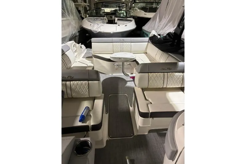 Slide: The Image of 2016 Sea Ray 270 Sundeck interior with luxurious seating and table setup. - 16