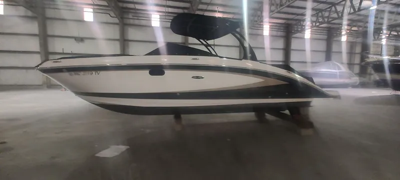 Slide: The Image of 2016 Sea Ray 270 Sundeck boat in a spacious indoor storage facility. - 3