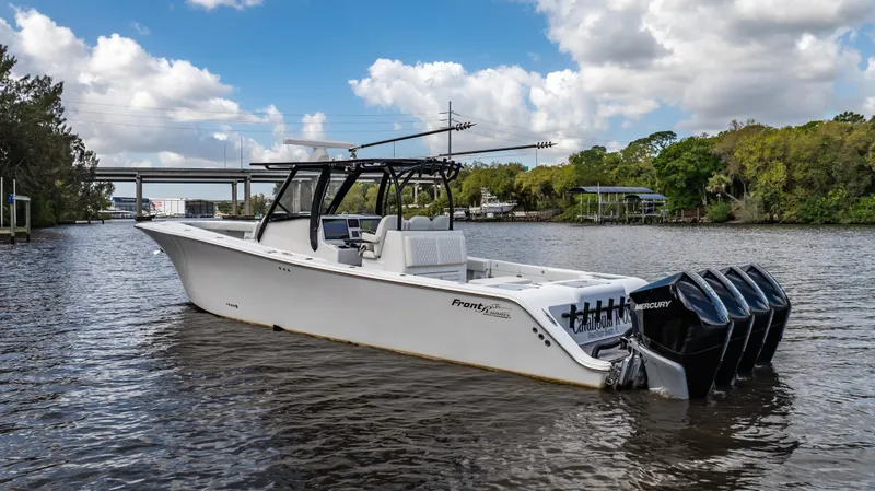 The Image of 2023 Front Runner 39 Center Console boat on a scenic river with four engines. - 0