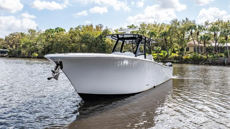 Slide: The Image of 2023 Front Runner 39 Center Console boat on a calm river with trees in the background. - 18