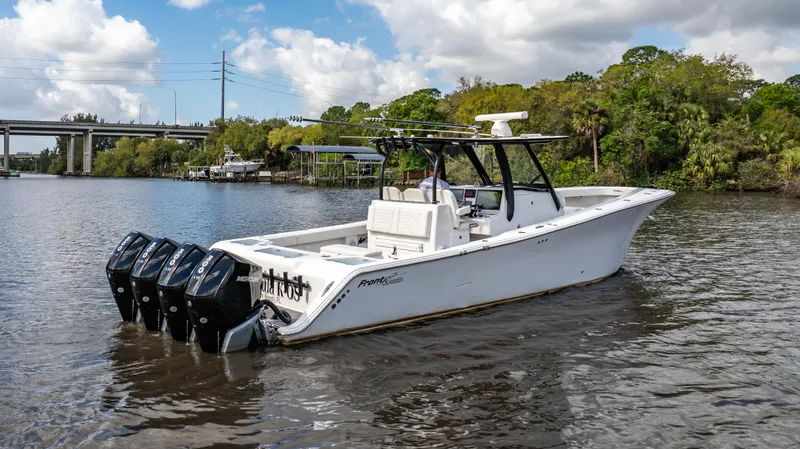 Slide: The Image of 2023 Front Runner 39 Center Console boat on a river with four outboard engines. - 20