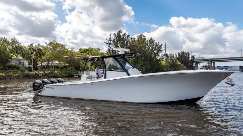 Slide: The Image of 2023 Front Runner 39 Center Console boat on a river under a cloudy sky. - 22