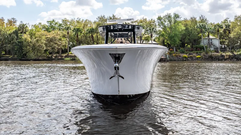 Slide: The Image of 2023 Front Runner 39 Center Console boat on calm water, surrounded by trees. - 7