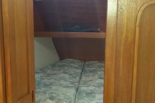 Slide: The Image of Cozy cabin interior of 1994 Catalina 320 sailboat with wooden finish and bedding. - 8