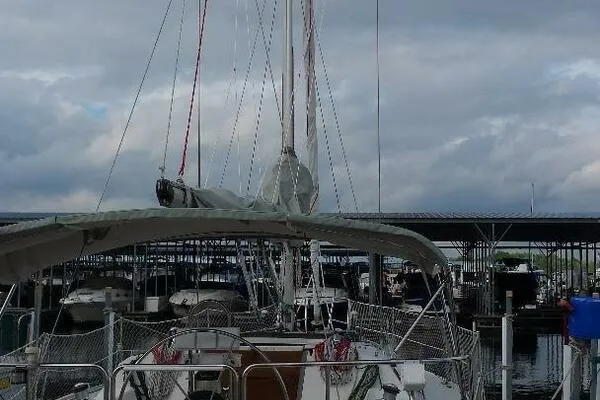 Slide: The Image of 1994 Catalina 320 sailboat docked at marina under cloudy sky. - 5