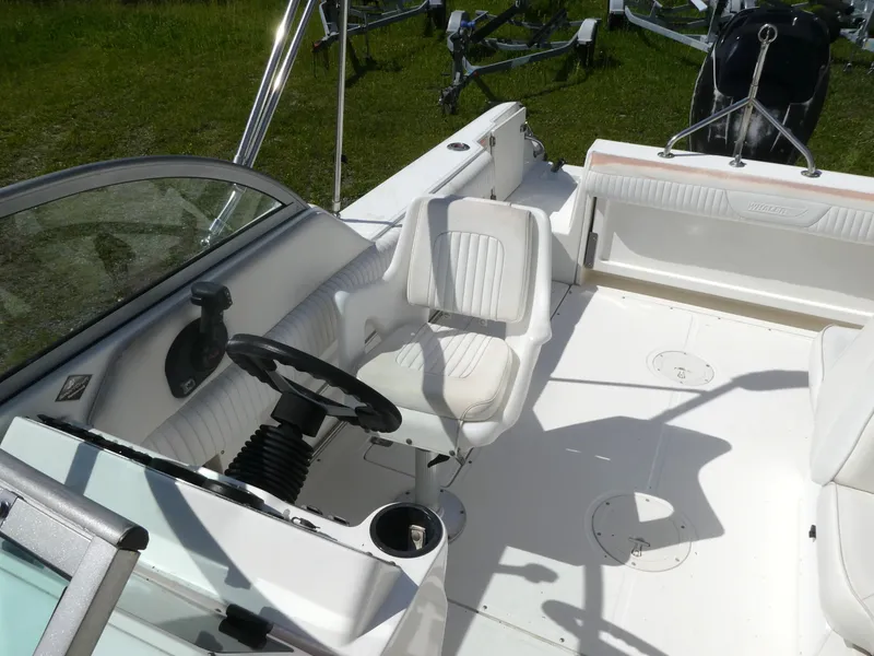 Slide: The Image of 2005 Boston Whaler 210 Ventura boat interior with steering wheel and seating. - 10