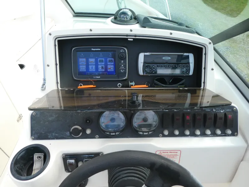 Slide: The Image of Dashboard of a 2005 Boston Whaler 210 Ventura boat with navigation and control instruments. - 12