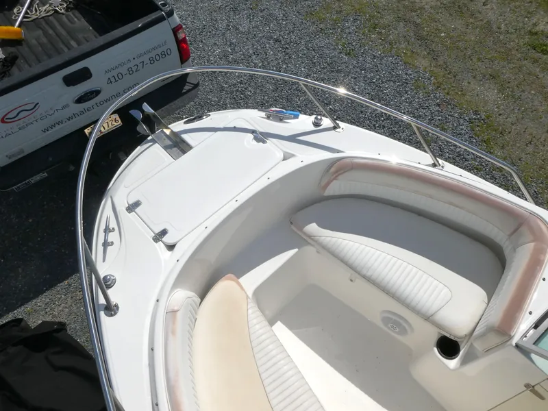 Slide: The Image of 2005 Boston Whaler 210 Ventura boat interior with white seating and railing. - 13