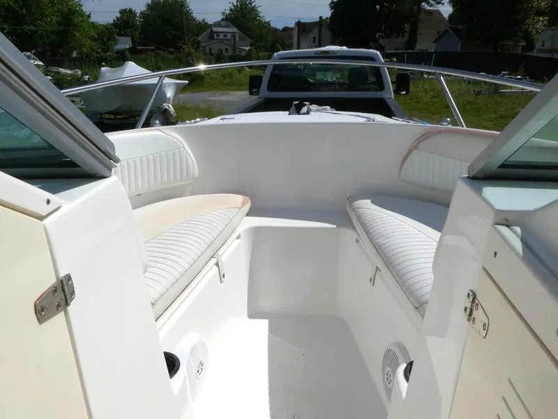 Slide: The Image of 2005 Boston Whaler 210 Ventura boat interior with white seating and open bow design. - 14