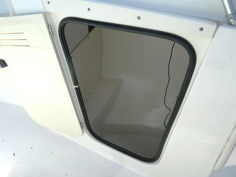 Slide: The Image of Open storage compartment on a 2005 Boston Whaler 210 Ventura boat. - 16