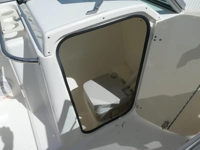 Slide: The Image of 2005 Boston Whaler 210 Ventura boat interior with compact marine toilet. - 17