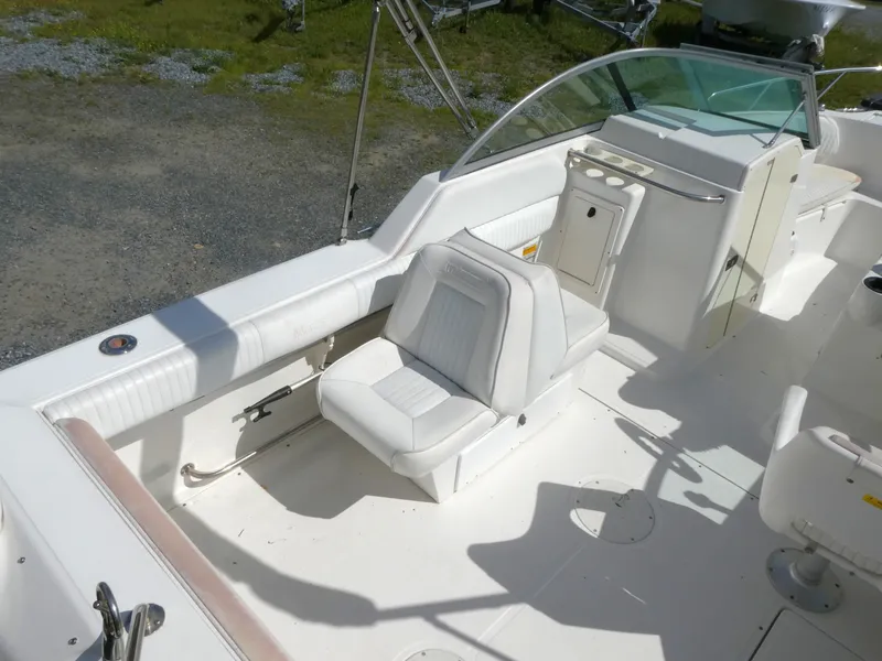 Slide: The Image of 2005 Boston Whaler 210 Ventura boat interior with white seating and console. - 6