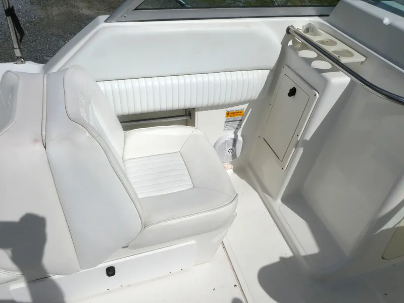 Slide: The Image of 2005 Boston Whaler 210 Ventura boat interior with white seating and storage compartment. - 8