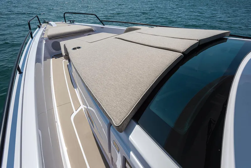 Slide: The Image of 2023 Axopar 45 Cross Cabin boat with sunbathing deck on calm water. - 10