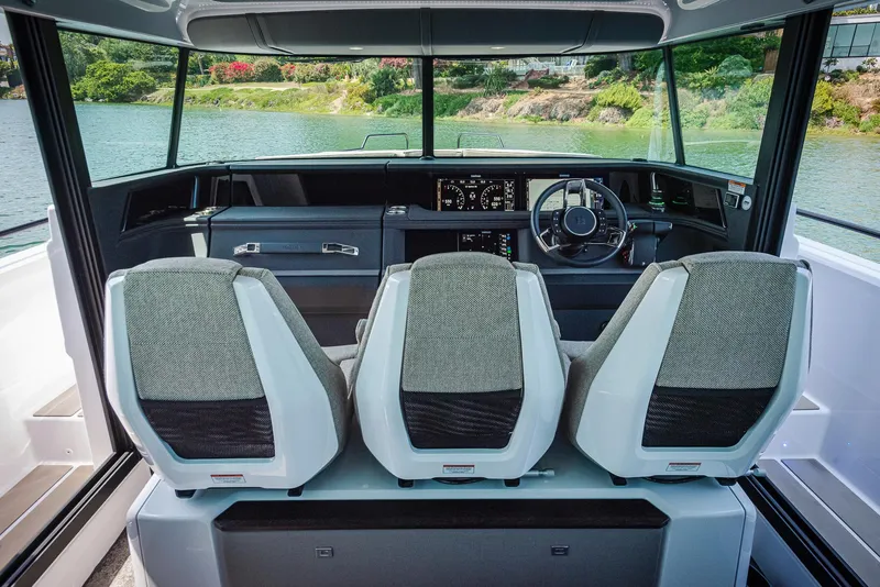 Slide: The Image of 2023 Axopar 45 Cross Cabin interior with modern seating and dashboard view. - 16