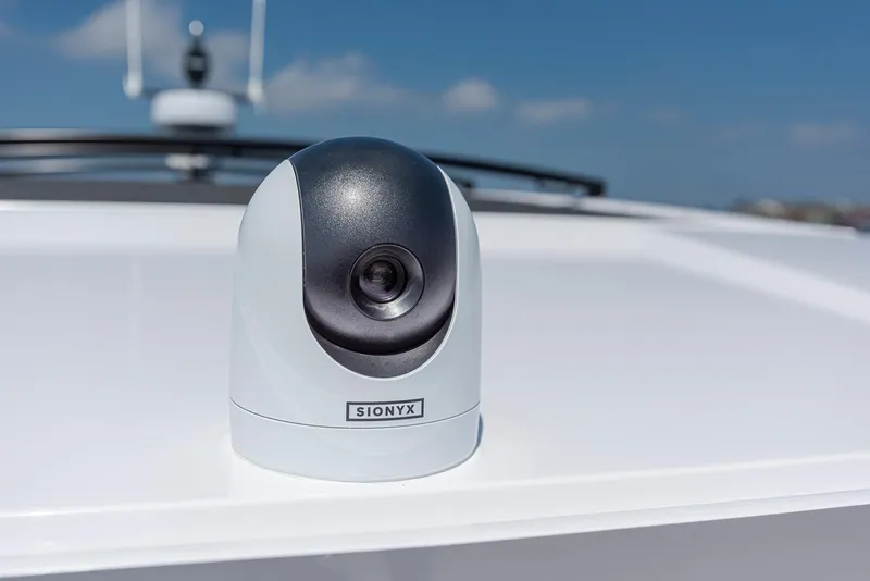 Slide: The Image of SIONYX camera on 2023 Axopar 45 Cross Cabin boat, clear sky background. - 19