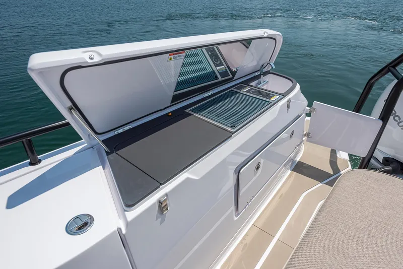 Slide: The Image of 2023 Axopar 45 Cross Cabin boat with open storage compartment on deck. - 28