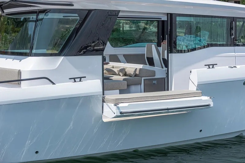 Slide: The Image of 2023 Axopar 45 Cross Cabin boat with open side door and modern interior design. - 30